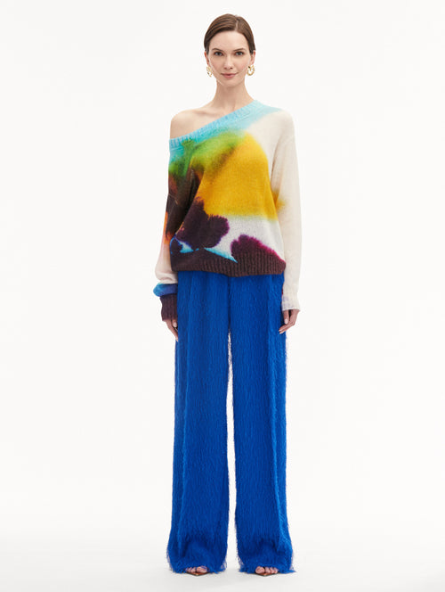 Abstract Watercolor Off-The-Shoulder Pullover Styled with Blue Pants Front View