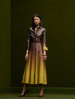 The model is wearing a long sleeve, collared-midi ombre dress from Oscar de la Renta's Fall 2024 Collection. 