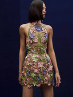 The model wears a flower embroidered halter mini dress.