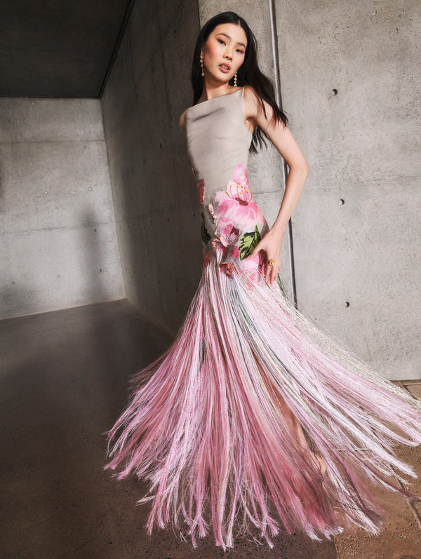 A model poses indoors in an Oscar de la Renta fringe gown from the Pre-Fall 2025 collection. 