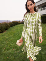 A model poses outside in an abstract gown from Oscar de la Renta’s Pre-Fall 2025 collection. 