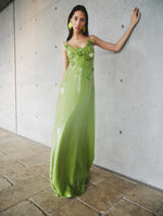 A model poses indoors in a green sequin dress from Oscar de la Renta’s Pre-Fall 2025 collection. 