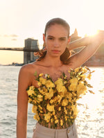 The model is wearing the organza rose bouquet blouse against the NYC skyline at sunset. 